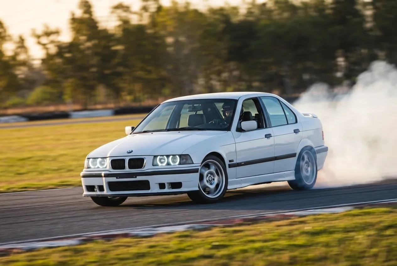 BMW E36 blanco drifteando con humo — la plataforma de drift por defecto en Argentina