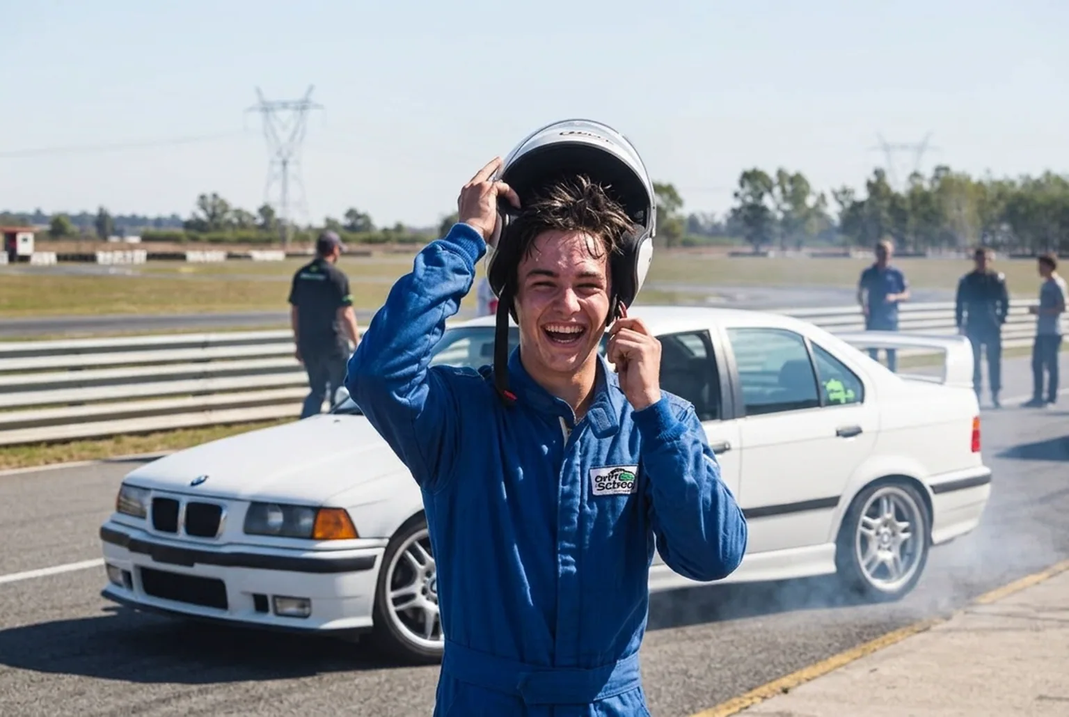 Alumno sonriendo y sacandose el casco despues de su primera tanda de drift junto al BMW E36